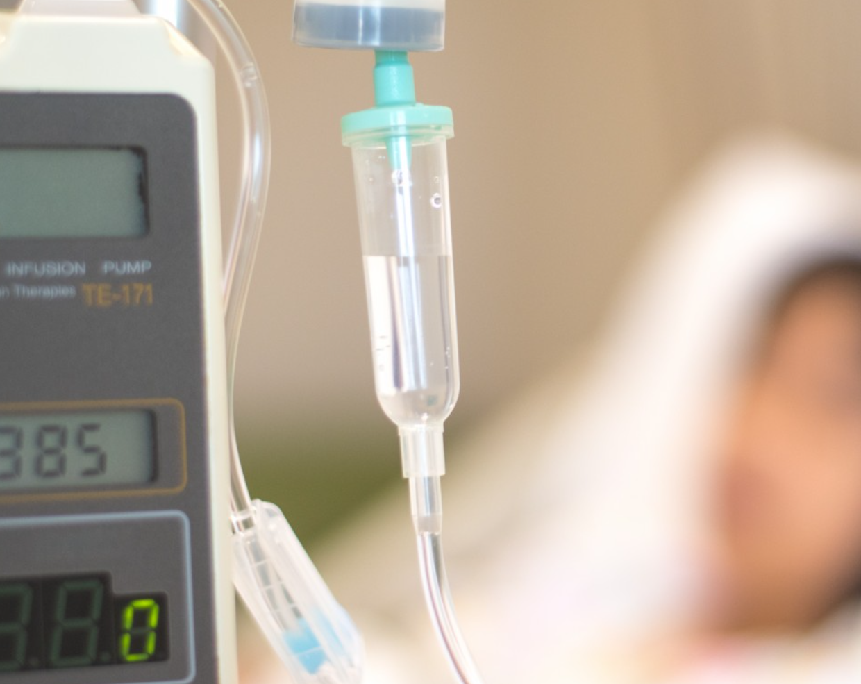 Nurse administering IV infusion therapy